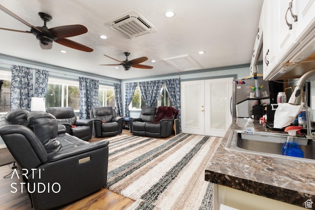 living area featuring wood finished floors, attic access, visible vents, ceiling fan, and recessed lighting