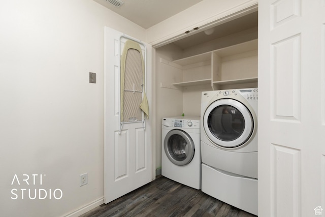 laundry area with baseboards, laundry area, washer and dryer, and dark wood-style floors