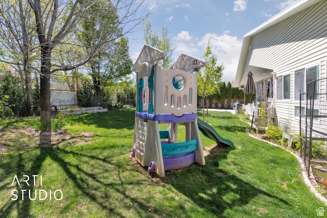 community play area featuring a lawn