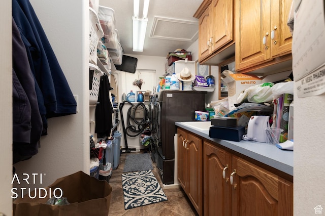 laundry area with washing machine and dryer, attic access, and cabinet space