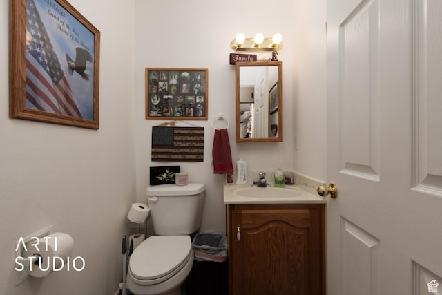 half bath featuring toilet and vanity
