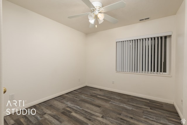 spare room featuring ceiling fan, baseboards, visible vents, and dark wood finished floors