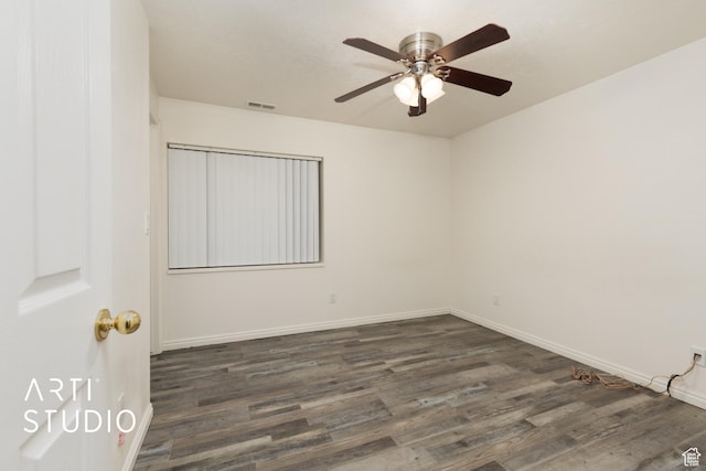 unfurnished room featuring baseboards, ceiling fan, dark wood finished floors, and visible vents