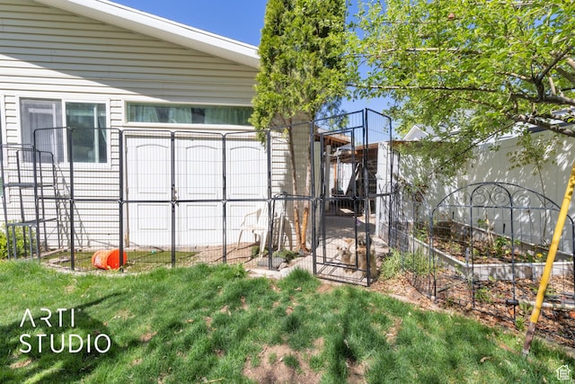 exterior space featuring a vegetable garden and fence