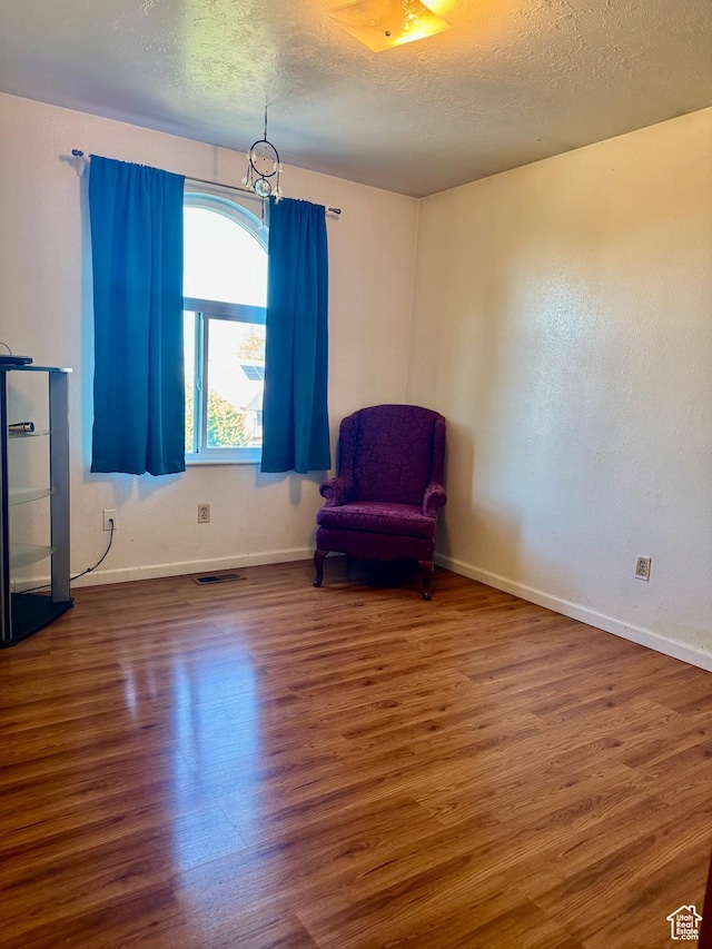 6367 W 4180 S, West Valley City, UT 84128 - unfurnished room with wood finished floors, a textured ceiling, and baseboards
