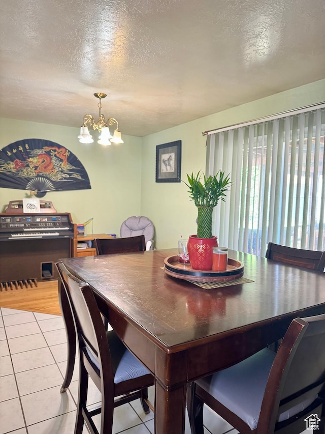 6367 W 4180 S, West Valley City, UT 84128 - dining room with a textured ceiling, a chandelier, and light tile patterned floors