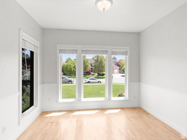 spare room with light wood-type flooring and baseboards