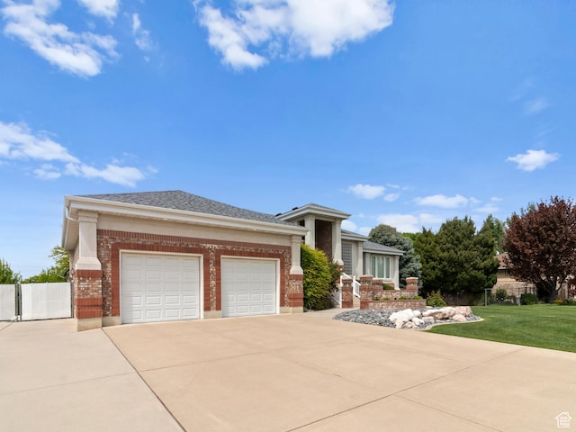 prairie-style house with brick siding, driveway, and an attached garage