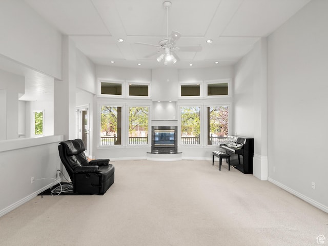 living room with carpet floors, a glass covered fireplace, recessed lighting, baseboards, and ceiling fan