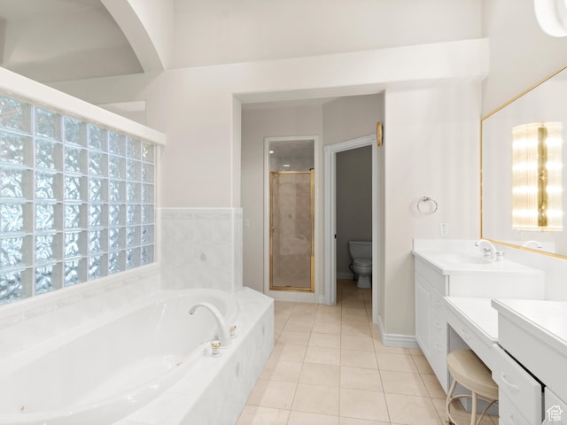 full bath with vanity, a stall shower, toilet, a bath, and tile patterned flooring