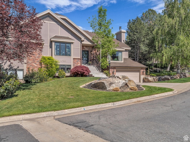 4760 S Meadow Creek Ln E, Ogden, UT 84403 - raised ranch featuring brick siding, driveway, a front yard, and an attached garage