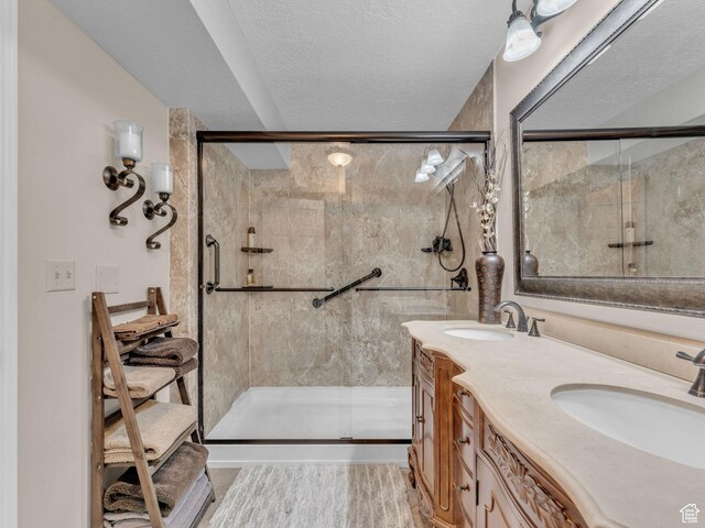 4760 S Meadow Creek Ln E, Ogden, UT 84403 - bathroom with a stall shower, double vanity, and a textured ceiling