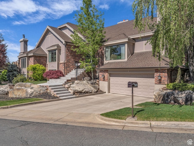 4760 S Meadow Creek Ln E, Ogden, UT 84403 - view of front facade with a garage, concrete driveway, brick siding, and roof with shingles