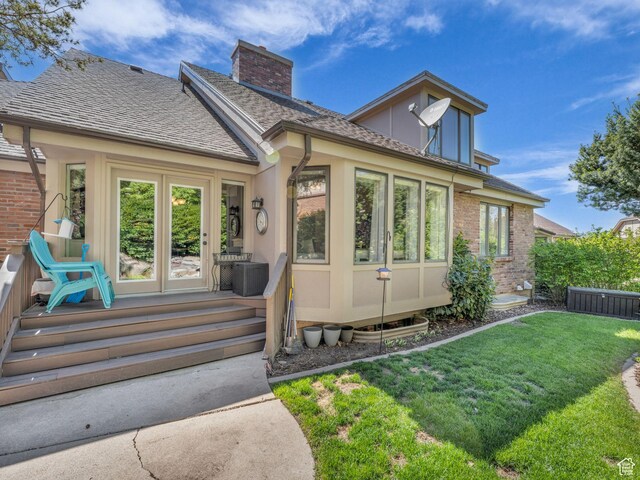 4760 S Meadow Creek Ln E, Ogden, UT 84403 - back of house with a yard, a chimney, a shingled roof, and brick siding