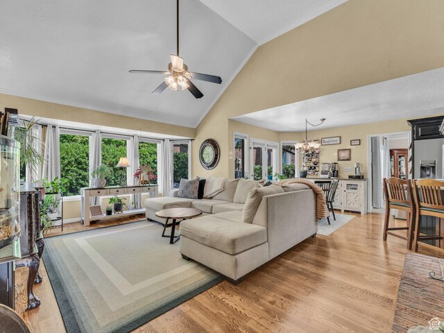 4760 S Meadow Creek Ln E, Ogden, UT 84403 - living area featuring healthy amount of natural light, a chandelier, light wood-style floors, ceiling fan, and high vaulted ceiling