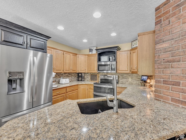 4760 S Meadow Creek Ln E, Ogden, UT 84403 - kitchen with appliances with stainless steel finishes, light stone countertops, backsplash, open shelves, and a textured ceiling