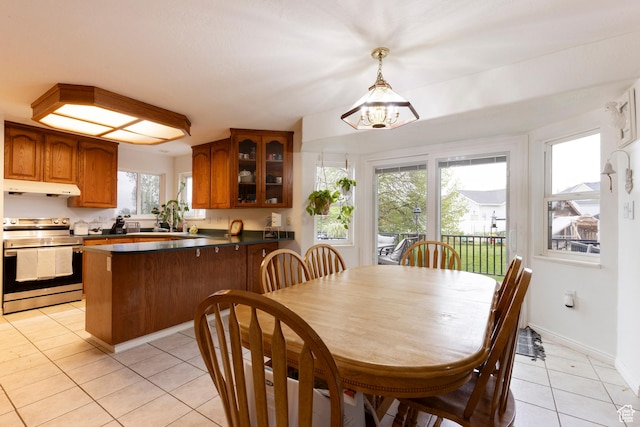 dining area with light tile patterned floors and baseboards
