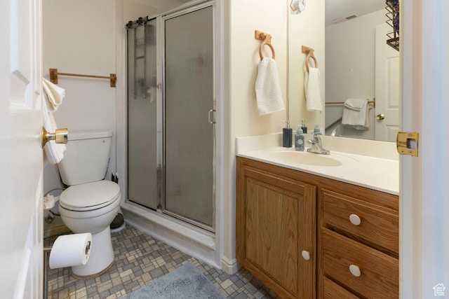 full bathroom with a stall shower, toilet, and vanity