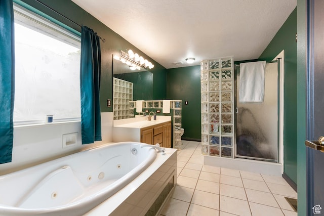 bathroom featuring toilet, a shower stall, tile patterned flooring, a tub with jets, and vanity