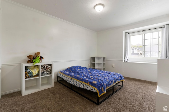 bedroom with carpet flooring and crown molding