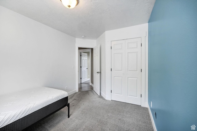 739 N 500 E, Logan, UT 84321 - bedroom featuring carpet, baseboards, a closet, and a textured ceiling