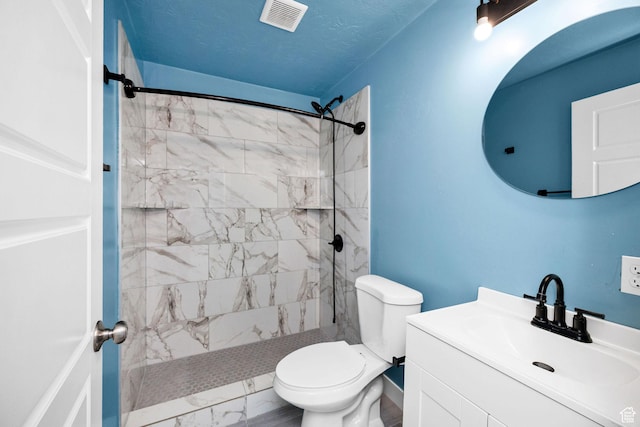739 N 500 E, Logan, UT 84321 - bathroom featuring tiled shower, toilet, marble finish flooring, and vanity
