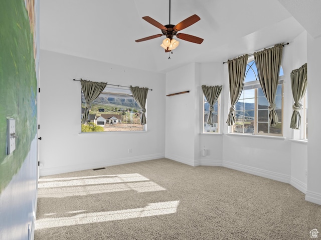 spare room featuring carpet flooring, ceiling fan, and baseboards