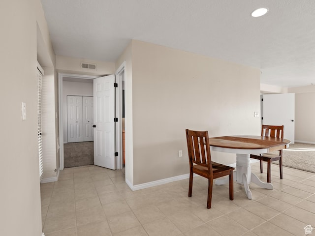 dining space featuring baseboards, light tile patterned floors, and recessed lighting