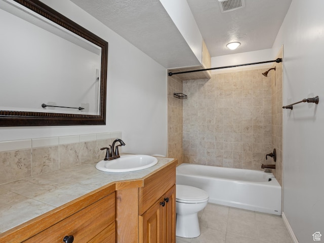 bathroom featuring tile patterned flooring, toilet, shower / washtub combination, and vanity