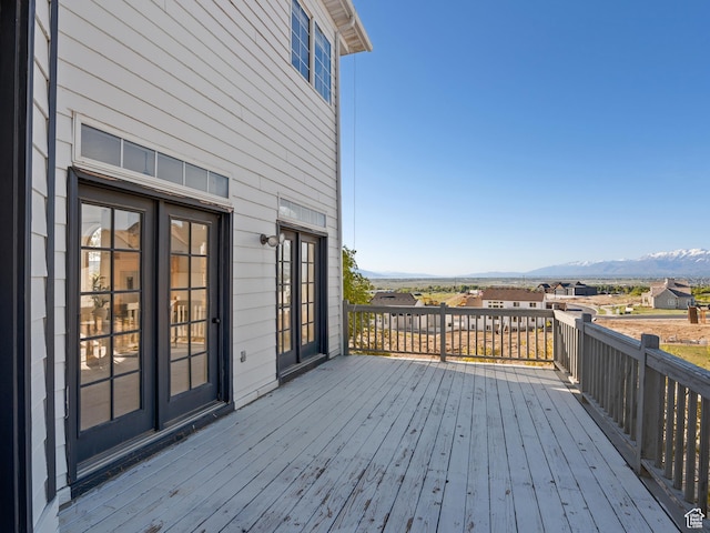 wooden deck featuring a mountain view and french doors