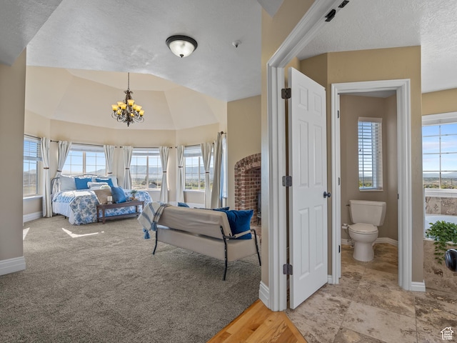 bedroom with a chandelier, baseboards, and a textured ceiling