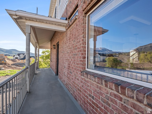 view of side of property featuring brick siding and a mountain view