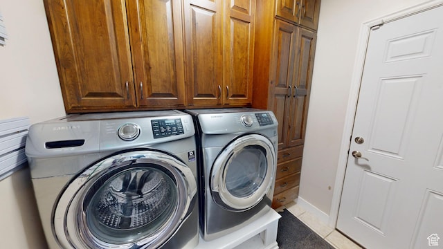 washroom with separate washer and dryer and cabinet space