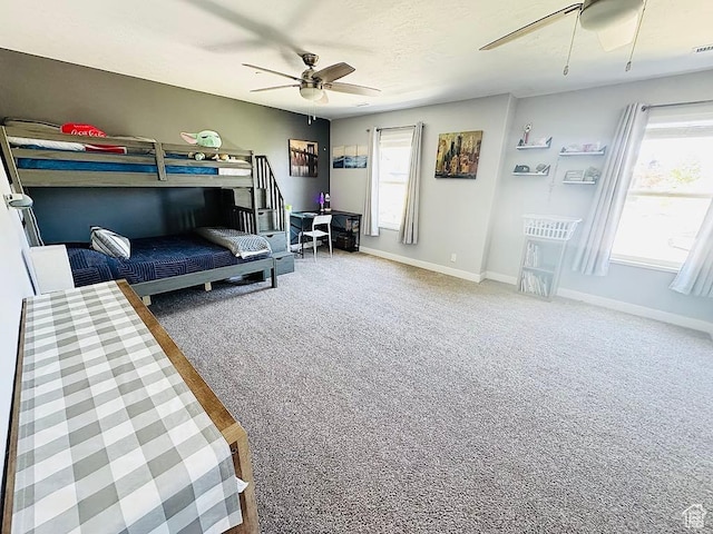 bedroom with baseboards, carpet flooring, and ceiling fan