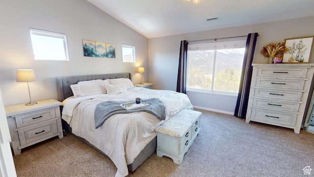 bedroom with lofted ceiling, light colored carpet, and baseboards