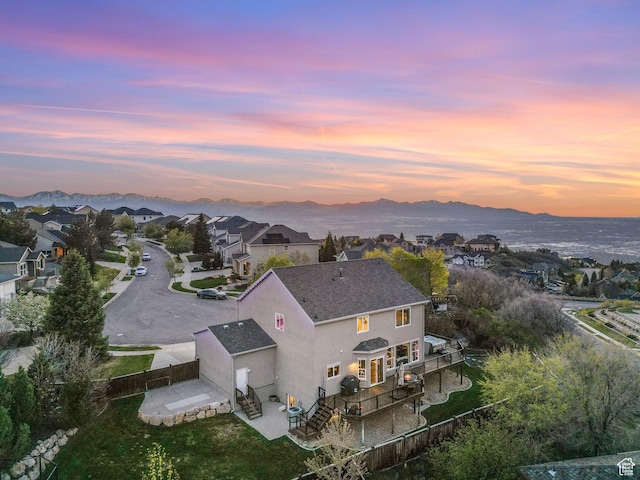 aerial view at dusk of a residential view and a mountain view