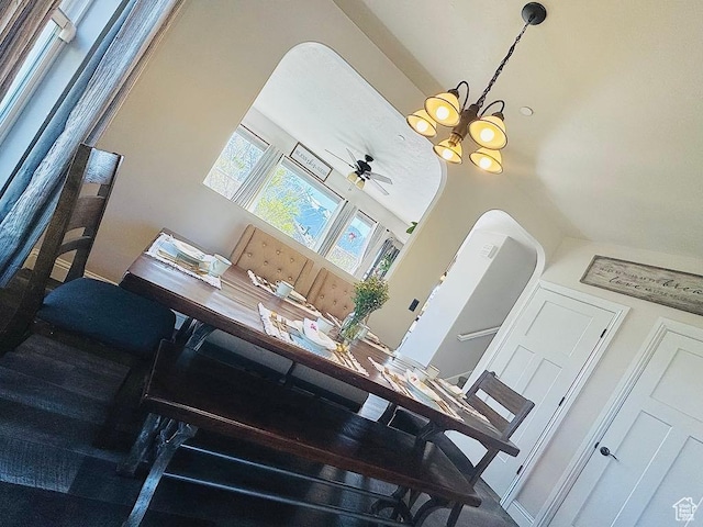 dining area view of a chandelier and a ceiling fan