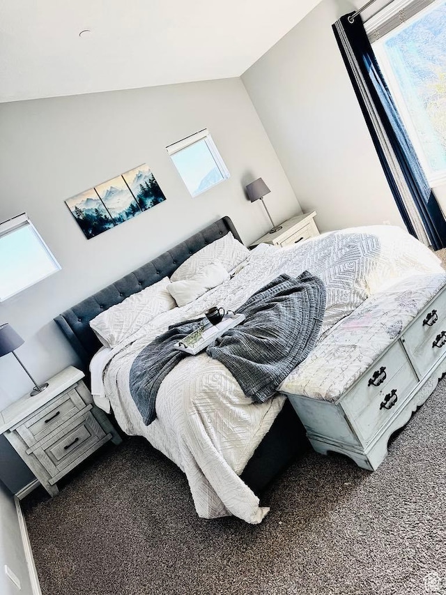 carpeted bedroom with lofted ceiling