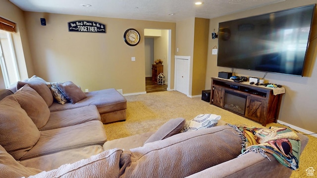 living room featuring carpet floors, baseboards, and recessed lighting