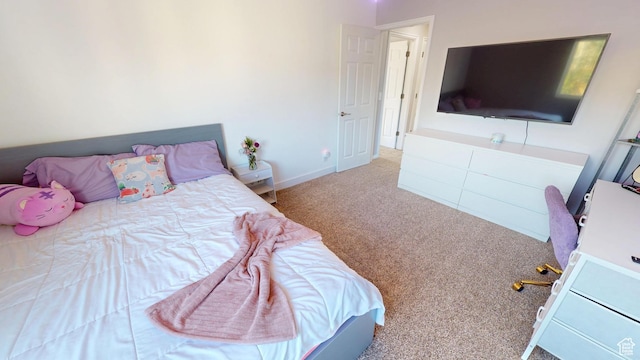 bedroom with carpet floors and baseboards