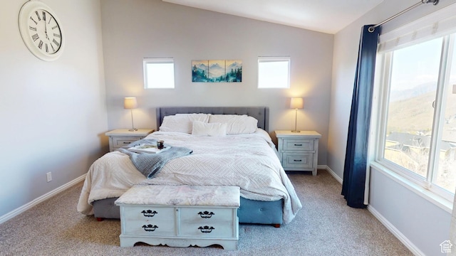 bedroom with light carpet, lofted ceiling, multiple windows, and baseboards