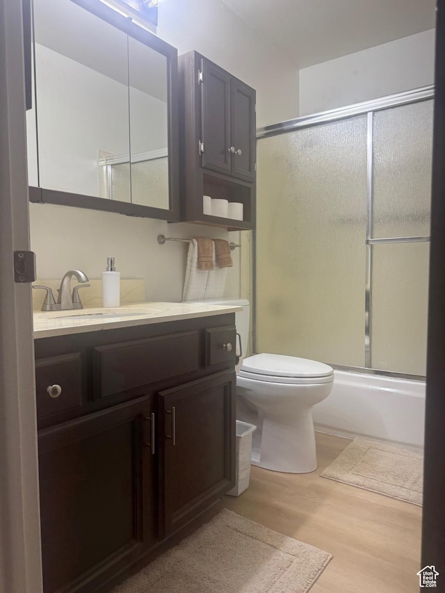 527 W Palisade Dr, Moab, UT 84532 - full bath with vanity, wood finished floors, and combined bath / shower with glass door