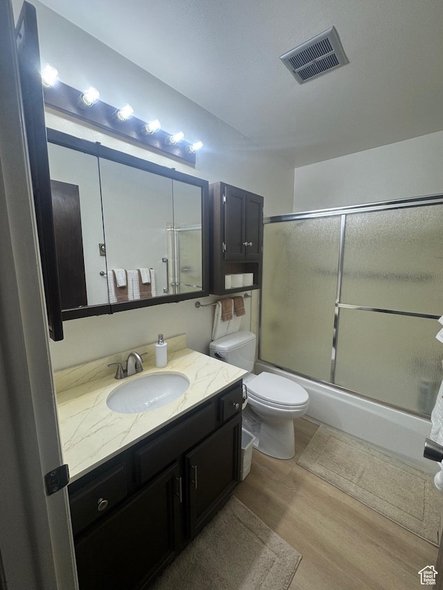 527 W Palisade Dr, Moab, UT 84532 - full bath featuring vanity, enclosed tub / shower combo, and wood finished floors