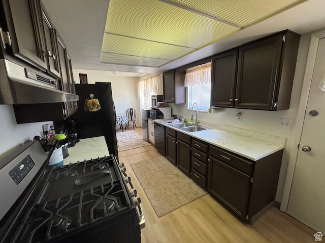 527 W Palisade Dr, Moab, UT 84532 - kitchen featuring black appliances, light wood-style floors, light stone countertops, and under cabinet range hood