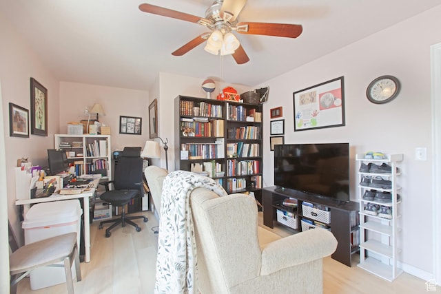 home office with wood finished floors and ceiling fan