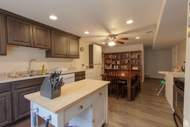 kitchen featuring a sink, range, ceiling fan, butcher block counters, and recessed lighting