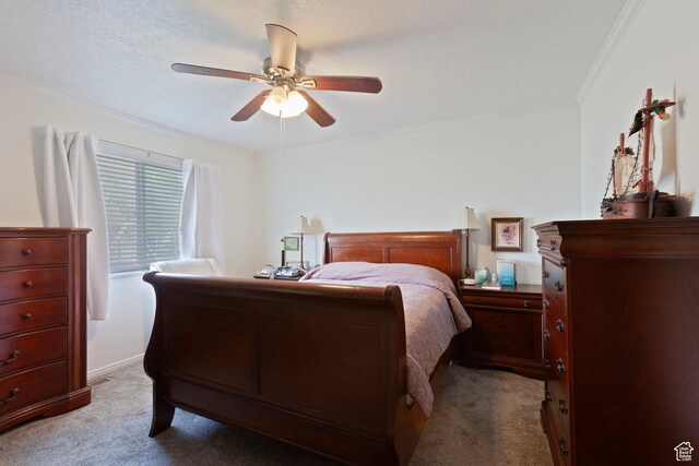 bedroom featuring light colored carpet, crown molding, and a ceiling fan