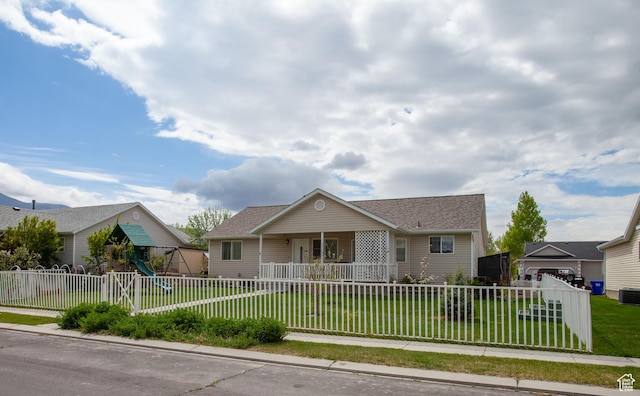 view of front facade with a playground, a porch, central AC unit, and roof with shingles