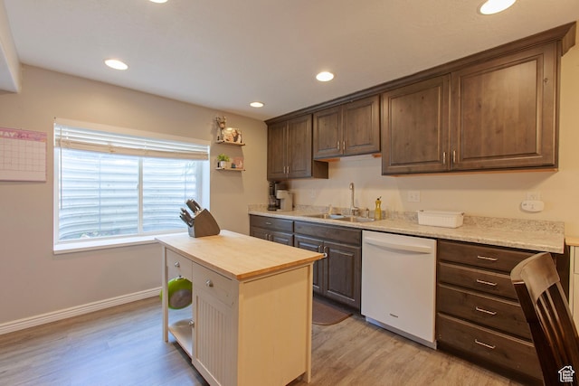 kitchen with dishwasher, a sink, light wood-style floors, baseboards, and recessed lighting