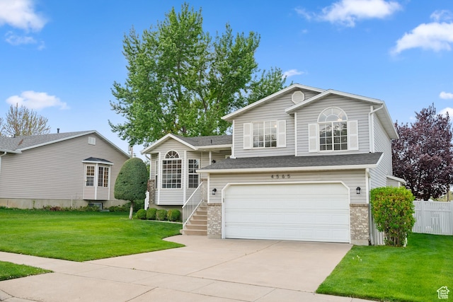 tri-level home with driveway and a garage